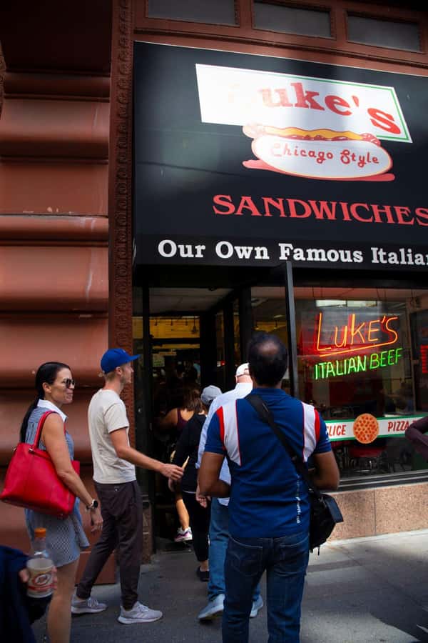 Chicago: The Ultimate Foodie Walking Tour with Tasty Stops - Starting beneath the Chicago Theatre marquee